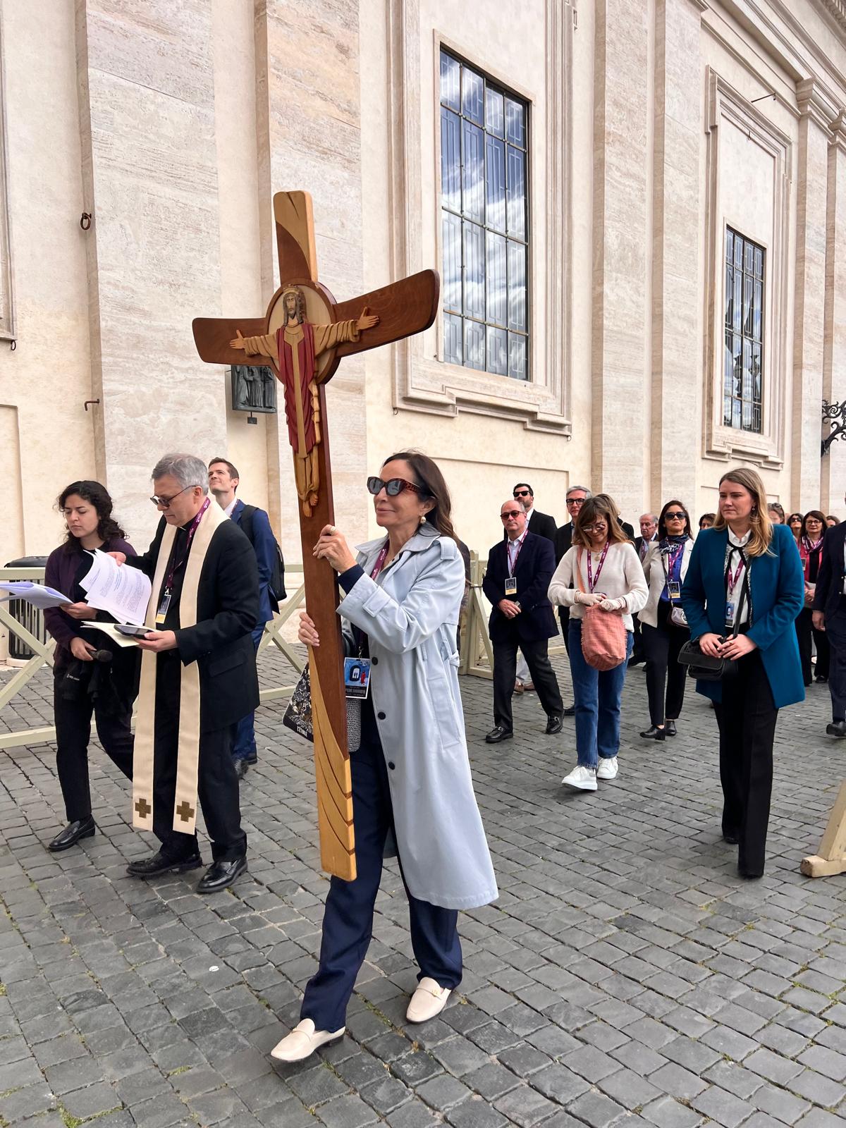 Procession carrying a wooden cross outside the Vatican
