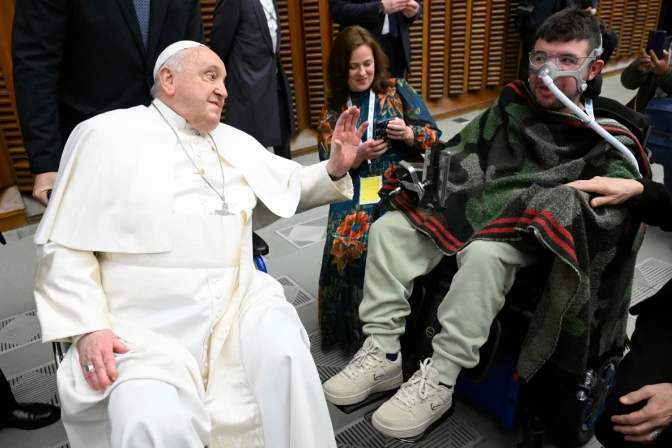 Pope Francis greeting Giacomo in his wheelchair